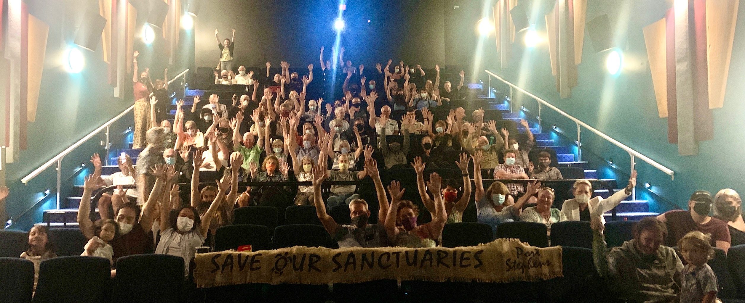 Nelson Bay Cinema goers with save our sanctuaries sign